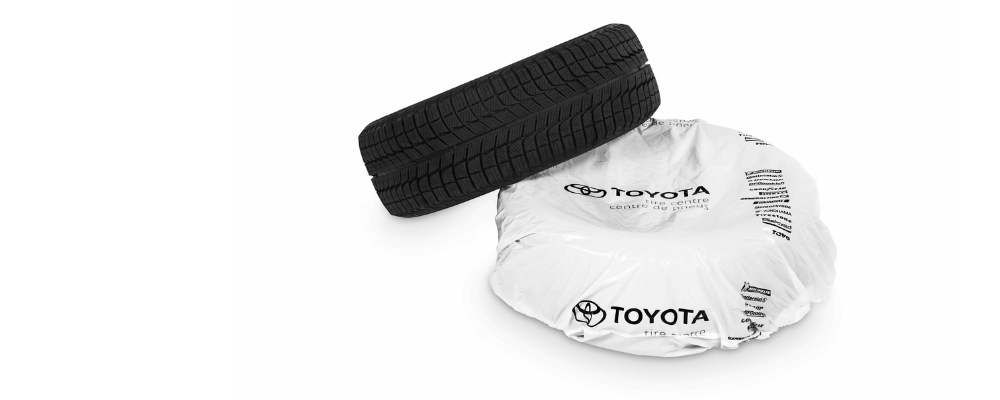 Two Toyota tires, one still in wrapping