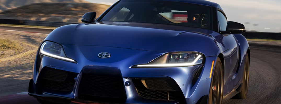 2025 Toyota GR Supra driving down a city street