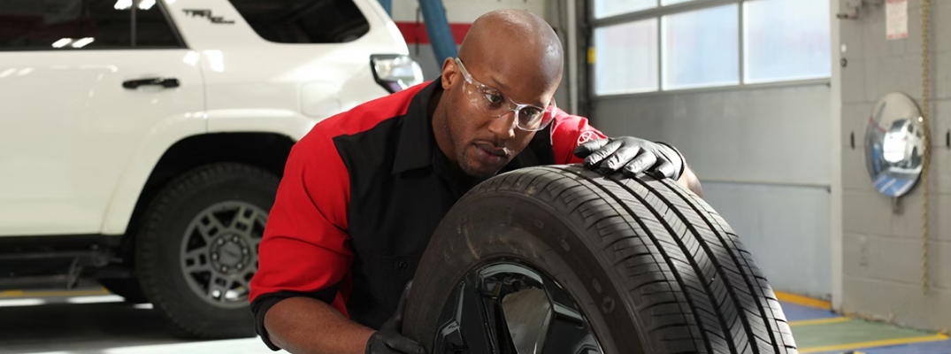 A technician installing a tire