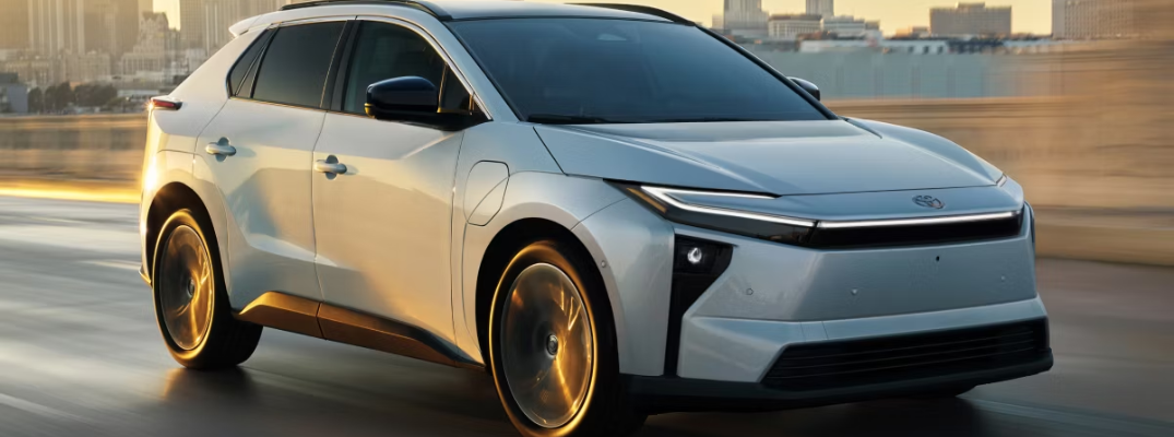 A Toyota bZ driving down a city street